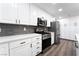 Bright kitchen boasts white cabinets, gray backsplash, and stainless steel appliances at 5225 Sandy Cactus Ln, Las Vegas, NV 89149