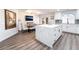 Kitchen area with island, and dining table with chairs and bench at 5225 Sandy Cactus Ln, Las Vegas, NV 89149