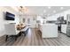 Open concept kitchen with white cabinets, stainless steel appliances, gray backsplash, and adjacent dining area at 5225 Sandy Cactus Ln, Las Vegas, NV 89149