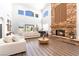 Bright living room with a stone fireplace, piano, and two sofas at 5225 Sandy Cactus Ln, Las Vegas, NV 89149