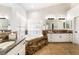 Bathroom with dual sinks, marble counters, and a tiled spa tub at 5225 Sandy Cactus Ln, Las Vegas, NV 89149
