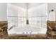 Cozy bathroom with a tub under a large bright window at 5225 Sandy Cactus Ln, Las Vegas, NV 89149