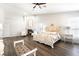 Bright main bedroom featuring a fireplace, wood floors, and a luxurious bed set at 5225 Sandy Cactus Ln, Las Vegas, NV 89149