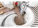 Beautiful curved staircase with white railings and a modern light fixture at 5225 Sandy Cactus Ln, Las Vegas, NV 89149