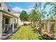 Expansive backyard features lush green grass, a covered patio, mature trees and landscaping at 532 Kavanagh Pl, Las Vegas, NV 89123