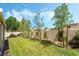 Well-maintained backyard with lush green grass, landscaping, trees, and block wall at 532 Kavanagh Pl, Las Vegas, NV 89123