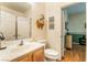 Bright bathroom with tile floors, wood cabinets, white sink, and bright natural light at 532 Kavanagh Pl, Las Vegas, NV 89123