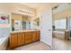 Bright bathroom featuring a double sink vanity and a separate tub and shower at 532 Kavanagh Pl, Las Vegas, NV 89123