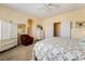 Bright bedroom with carpet, white furniture, ceiling fan, and ensuite bathroom and closet access at 532 Kavanagh Pl, Las Vegas, NV 89123