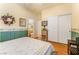 Bright bedroom with wood floors, ensuite bathroom, large closet, and floral wallpaper accent at 532 Kavanagh Pl, Las Vegas, NV 89123