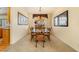 Dining room features a large glass table, six chairs, carpet, and large window for natural light at 532 Kavanagh Pl, Las Vegas, NV 89123