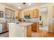 Bright kitchen features wood cabinets, stainless appliances, kitchen island, and breakfast nook area at 532 Kavanagh Pl, Las Vegas, NV 89123