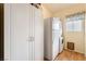 Clean laundry room with ample storage cabinets, a stacked washer/dryer, and linoleum flooring at 532 Kavanagh Pl, Las Vegas, NV 89123