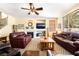 Spacious living room with a fireplace, ceiling fan and comfortable leather seating at 532 Kavanagh Pl, Las Vegas, NV 89123