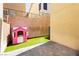 Private backyard with artificial grass, pink playhouse, and a secure walled perimeter at 551 Swiss Cottage Ave, Las Vegas, NV 89178