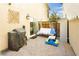 Enclosed patio with pavers, outdoor furniture, grill, and decorative wall art; ideal for entertaining at 551 Swiss Cottage Ave, Las Vegas, NV 89178