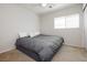 Relaxing bedroom featuring a plush bed, ceiling fan and a bright window at 551 Swiss Cottage Ave, Las Vegas, NV 89178