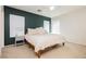 Well-lit bedroom featuring a large bed, soothing green accent wall, and natural light at 551 Swiss Cottage Ave, Las Vegas, NV 89178