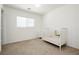 Bright Bedroom features neutral walls, carpet, and a white crib at 551 Swiss Cottage Ave, Las Vegas, NV 89178