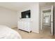 Bedroom featuring a dresser with TV and a doorway to the hallway at 551 Swiss Cottage Ave, Las Vegas, NV 89178