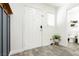 Inviting entryway featuring wood-look tile flooring, a crisp white door, and a charming accent plant at 551 Swiss Cottage Ave, Las Vegas, NV 89178