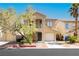 Charming two-story home featuring desert landscaping, two-car garages, and a cozy front porch, creating an inviting curb appeal at 551 Swiss Cottage Ave, Las Vegas, NV 89178