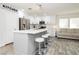 Stylish kitchen with white cabinets, stainless appliances, and a large island with bar seating at 551 Swiss Cottage Ave, Las Vegas, NV 89178