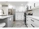 Kitchen features white cabinetry, stainless steel appliances, and island seating at 551 Swiss Cottage Ave, Las Vegas, NV 89178