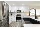 Modern kitchen features sleek appliances, white cabinets, and a stylish black faucet at 551 Swiss Cottage Ave, Las Vegas, NV 89178