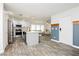 Bright, open kitchen features white cabinets, stainless appliances, and an island with seating at 551 Swiss Cottage Ave, Las Vegas, NV 89178