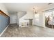 Open living room with wood-look tile, shiplap accent wall, and sliding door to the patio at 551 Swiss Cottage Ave, Las Vegas, NV 89178