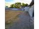 This backyard has a large vacant lot with a block wall and grass and gravel at 5617 Alfred Dr, Las Vegas, NV 89108