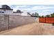 A gated backyard entrance and block wall surrounds a dirt lot, offering an intriguing development opportunity at 5617 Alfred Dr, Las Vegas, NV 89108
