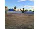 Large, vacant lot with a block wall and palm trees visible in the background at 5617 Alfred Dr, Las Vegas, NV 89108