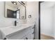 Bathroom with a modern vanity featuring white countertops, black hardware and fixtures, and sleek lighting at 5617 Alfred Dr, Las Vegas, NV 89108