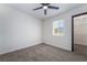 Bedroom with plush carpeting, modern fan, and window to the outside at 5617 Alfred Dr, Las Vegas, NV 89108