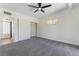 Spacious bedroom with a ceiling fan, plush carpet, ample natural light, and closet at 5617 Alfred Dr, Las Vegas, NV 89108