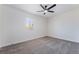 Serene bedroom with plush carpet, a window providing natural light, and a ceiling fan at 5617 Alfred Dr, Las Vegas, NV 89108