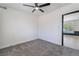 Bedroom featuring plush gray carpeting, a modern fan, and a view to other room at 5617 Alfred Dr, Las Vegas, NV 89108