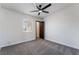 Bedroom featuring plush gray carpeting, a modern fan, and a sunny window at 5617 Alfred Dr, Las Vegas, NV 89108