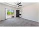 Light filled bedroom with a ceiling fan, carpet, and access to a sliding glass door to the exterior at 5617 Alfred Dr, Las Vegas, NV 89108