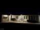 Nighttime view of a single-story home with a decorative front door and maintained landscaping at 5617 Alfred Dr, Las Vegas, NV 89108