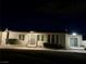 Exterior view of home at night with well-manicured landscaping and walkway at 5617 Alfred Dr, Las Vegas, NV 89108