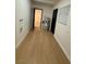 Hallway with wood-look floors, utility closet and a door to another room at 5617 Alfred Dr, Las Vegas, NV 89108