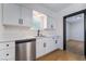 A modern kitchen featuring stainless steel appliances, quartz countertops, and shaker cabinets at 5617 Alfred Dr, Las Vegas, NV 89108