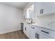 Bright kitchen featuring white cabinetry, stylish black hardware, quartz countertops, and stainless steel appliances at 5617 Alfred Dr, Las Vegas, NV 89108