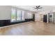 An open-concept living room with lots of natural light, a ceiling fan, and wood-look flooring at 5617 Alfred Dr, Las Vegas, NV 89108