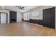 Bright living room with a modern ceiling fan, brick fireplace, and large windows at 5617 Alfred Dr, Las Vegas, NV 89108