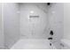 Beautiful white and gray marble-like tiling in shower with black fixtures at 5617 Alfred Dr, Las Vegas, NV 89108