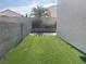 Manicured, zero-scape yard with artificial turf and a privacy wall at 6043 Cape Clairmont Ct, North Las Vegas, NV 89031